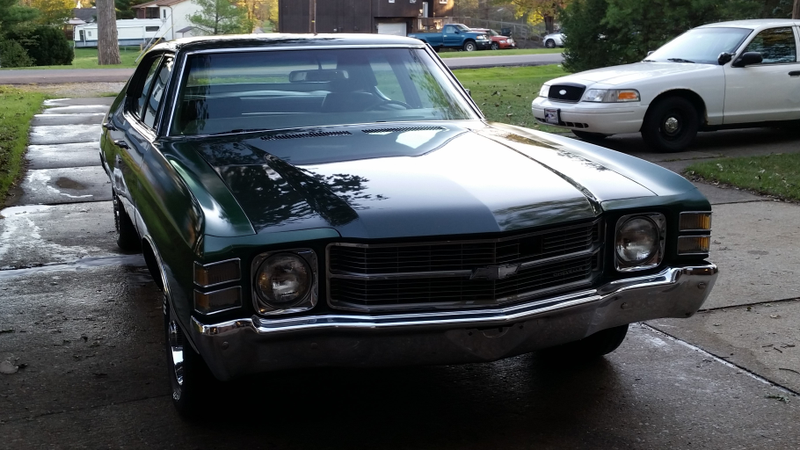 The filthy crown vic quietly broods in the background